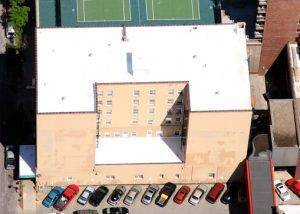 aerial shot of multi-story apartment building roof downtown